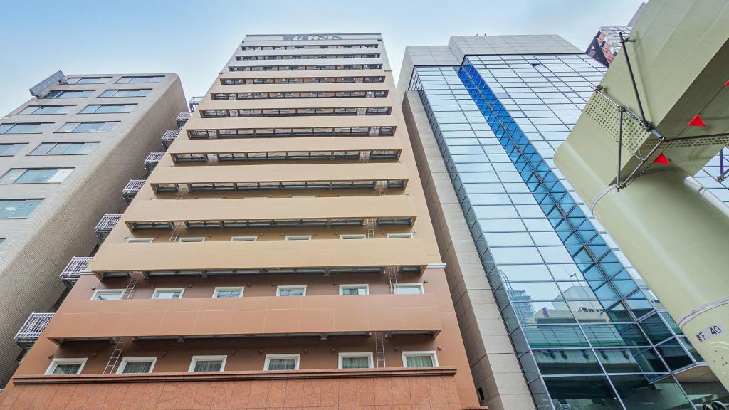 a tall building with many windows at Toyoko Inn Osaka Namba in Osaka