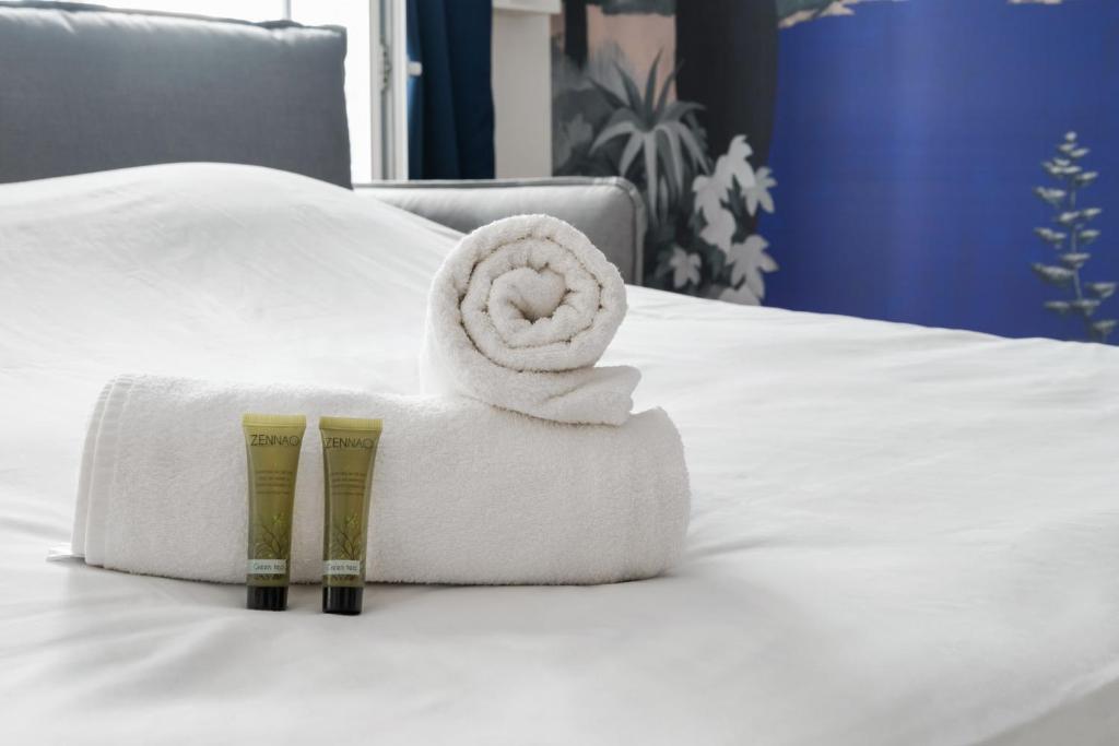 a towel on a bed with at Renovated studio in the 6th district of Paris - Welkeys in Paris