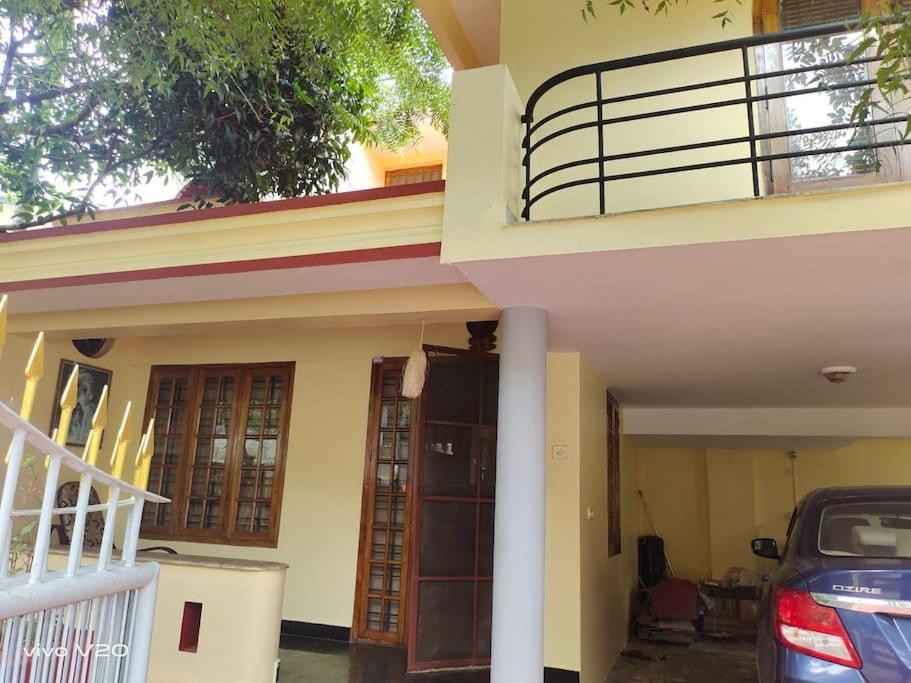 a house with a car parked in front of it at Entire 4 Bedroom villa in Trivandrum