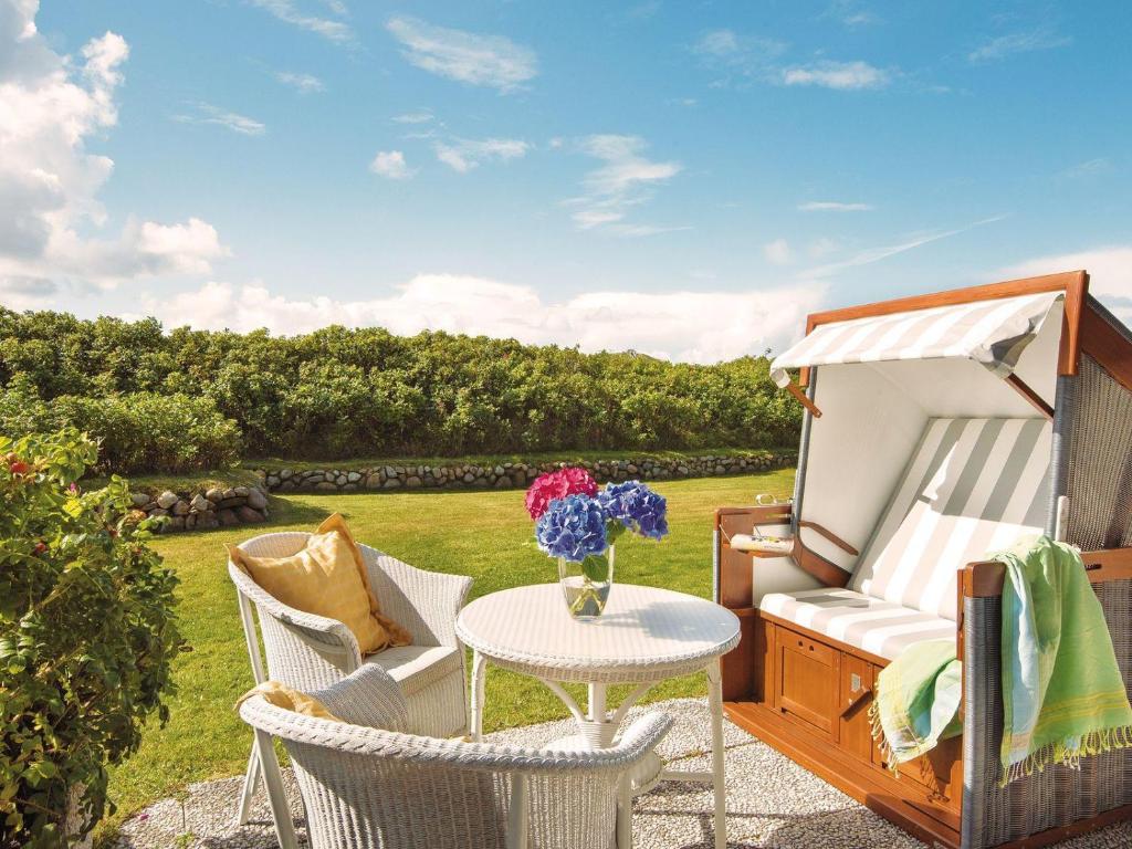 a patio with a table and chairs and a tent at Kampen-Kliff-3 in Kampen