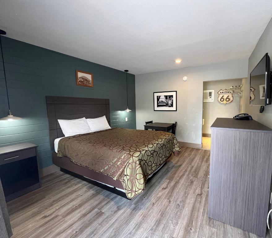 a hotel room with a bed and a television at Mountain View Inn in Flagstaff