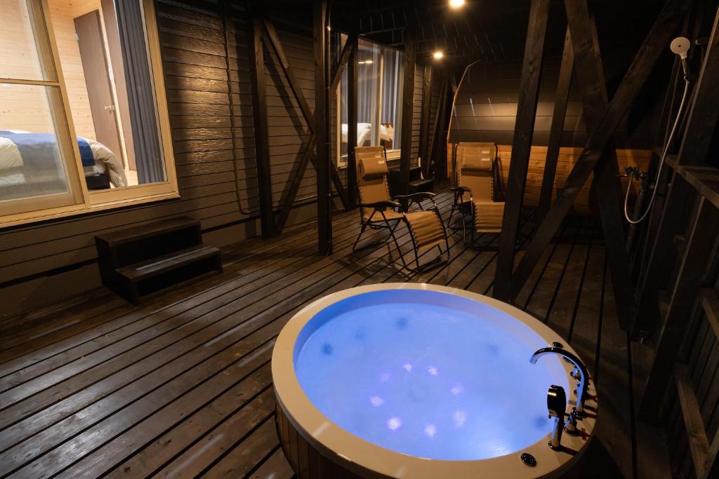 a bathroom with a bath tub in a room at Villa Noël HAKONE FUJI Sauna&Open Air Bath in Hakone