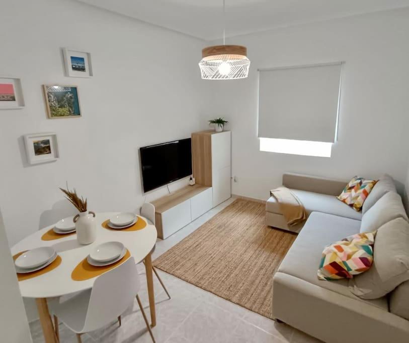 a living room with a couch and a table at Apartamento BERO in Santoña