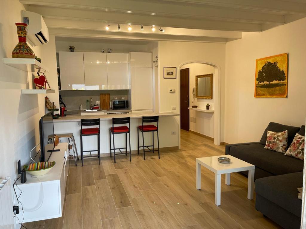 een woonkamer en een keuken met een bank en een tafel bij Casa di Paolino in Porto Valtravaglia