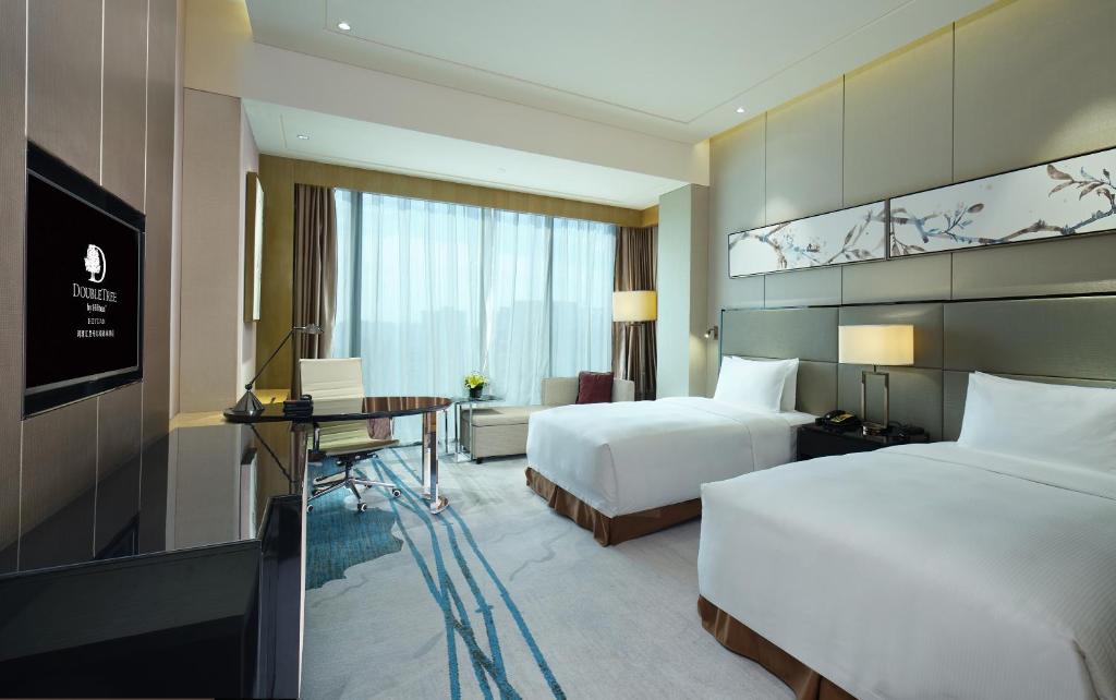 Postel nebo postele na pokoji v ubytování DoubleTree by Hilton Heyuan