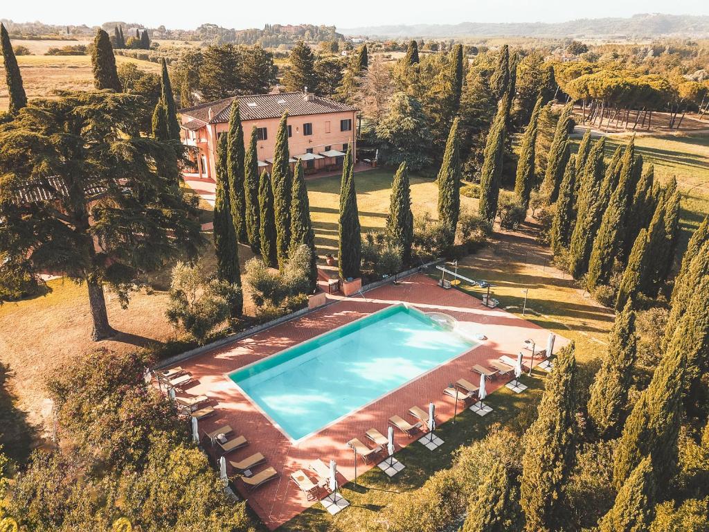 an overhead view of a swimming pool in a field with trees at Agriturismo Terra Di Dio Toscanizzazione in Capannoli