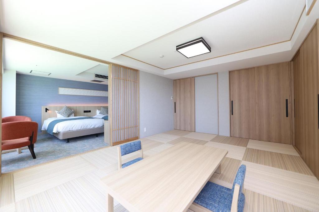 Postel nebo postele na pokoji v ubytování Hotel New Akao