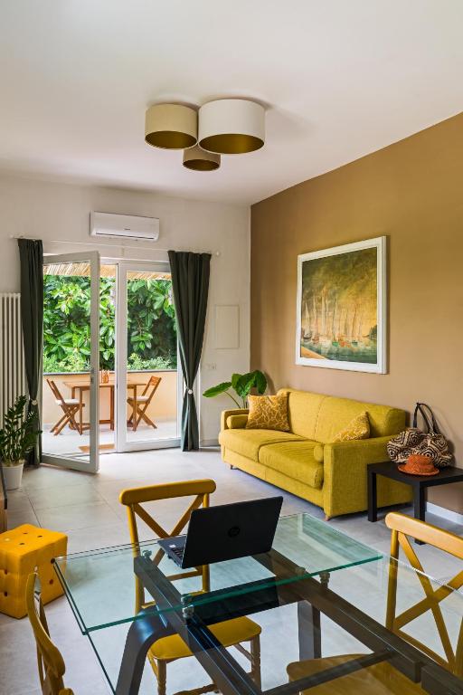 a living room with a yellow couch and a table at Zagara 139 in Ischia Town