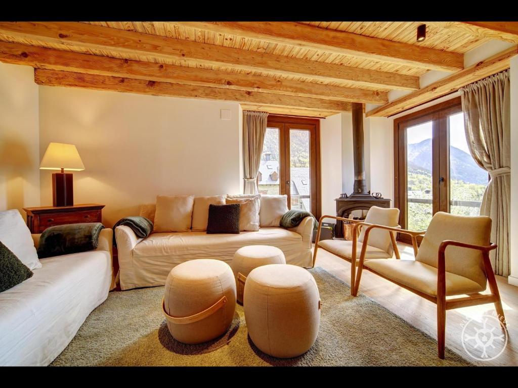 a living room with a couch and chairs and a table at CASA CORILHA de Alma de Nieve in Salardú