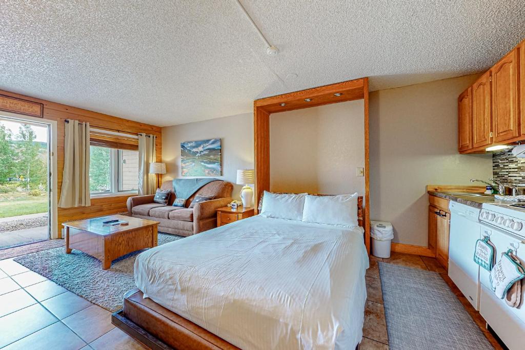 a bedroom with a bed and a living room at The Inn at Silvercreek 432 in Granby