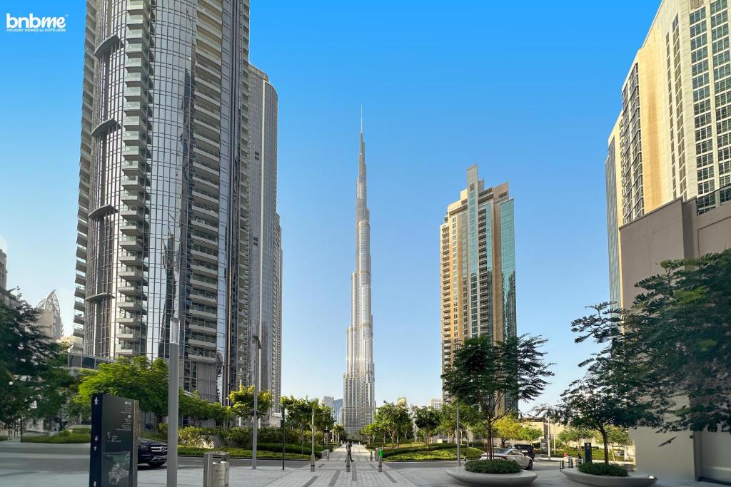 a view of a city with tall buildings at bnbme - Luxury 1BR Apt w Burj Khalifa Views Pool Gym & Prime Location Near Dubai Mall in Dubai