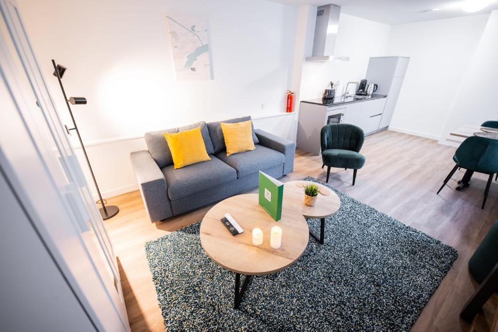 a living room with a couch and a table at Charming 60m2 One-Bedroom Apartment in Tiel
