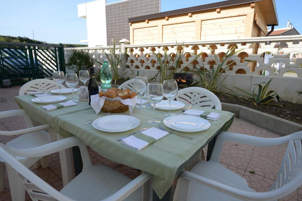 a table with plates and wine glasses on a patio at ITALY-HOUSE Piviere 5 Termoli Molise in Termoli