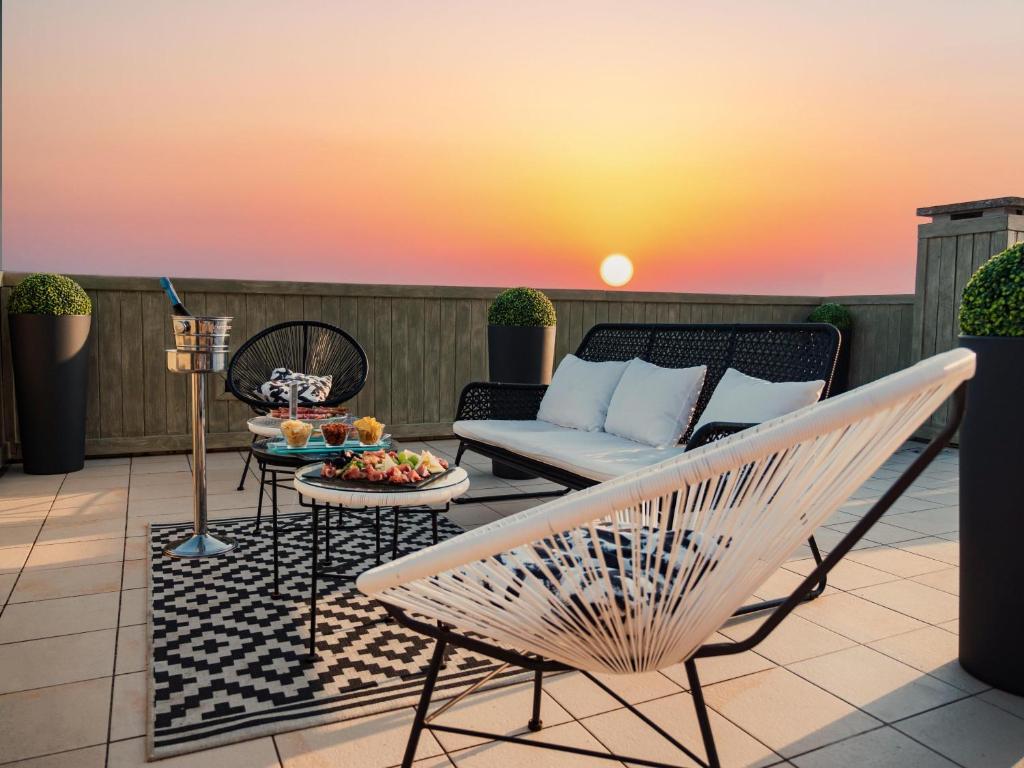 a patio with a couch and a table at Hotel & Residence Venezia 2000 in Venice-Lido