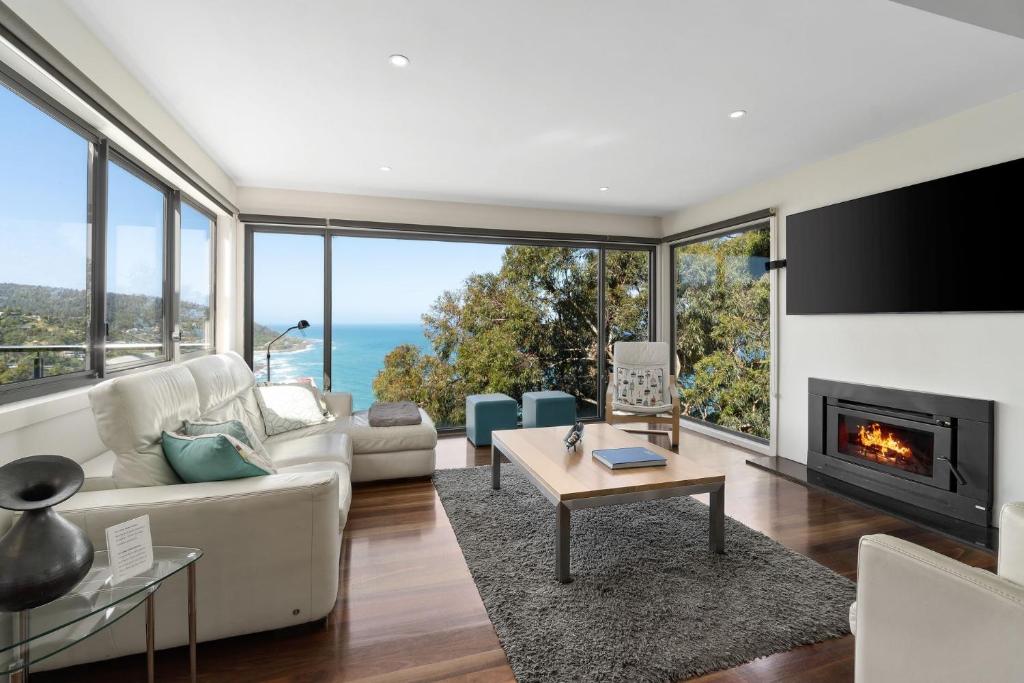 a living room with a couch and a fireplace at Azure in Wye River