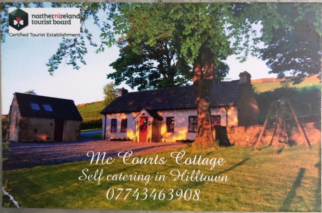 a picture of a house with a tree at Mc Courts Cottage in Hilltown