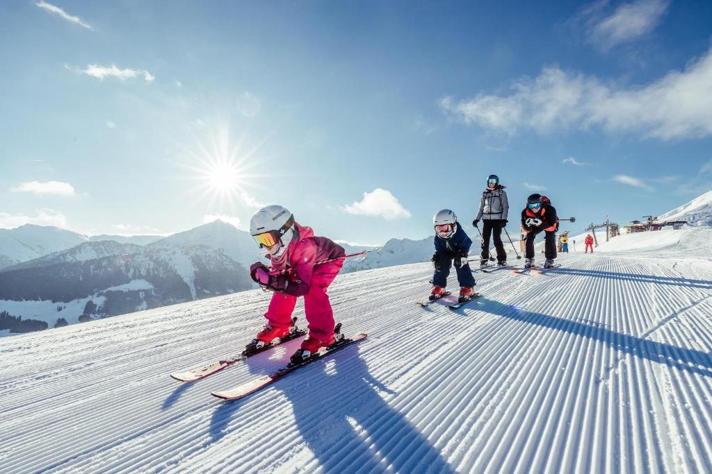 a group of people skiing down a snow covered slope at Chalet Innertal in Inneralpbach