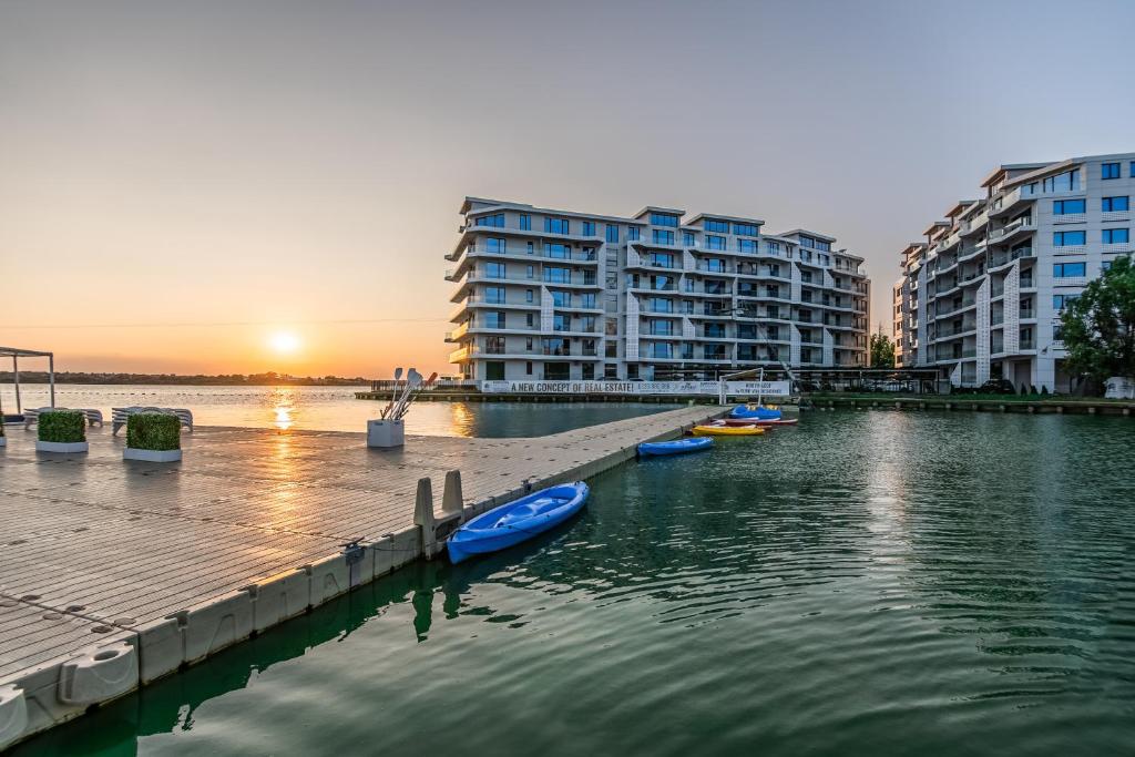 a group of boats in a body of water with buildings at The 502 Mamaia in Mamaia
