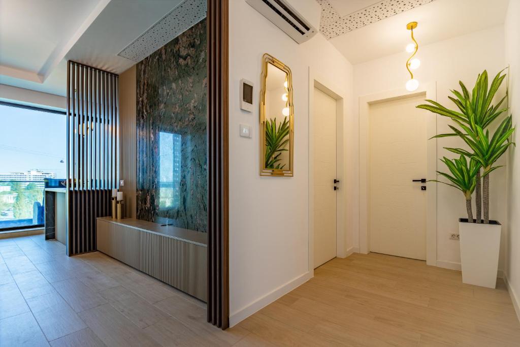 a hallway with a large mirror and a plant at The 502 Mamaia in Mamaia