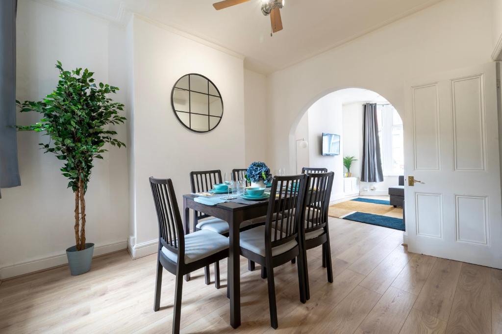 a dining room with a table and chairs at Luxury Liverpool Accommodation in Liverpool