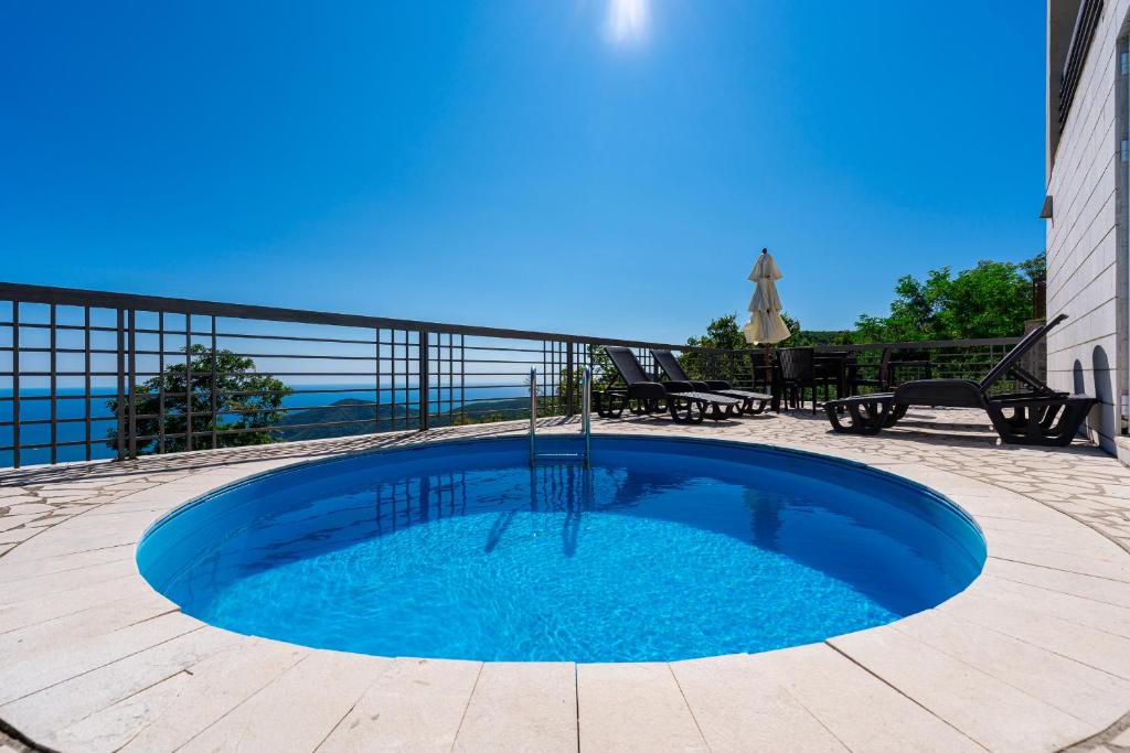 a large blue pool in the middle of a patio at Villas Monte Hill in Budva