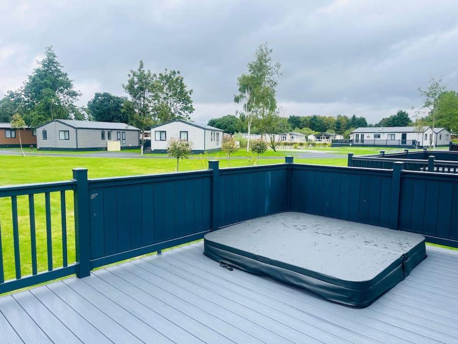 a mattress sitting on top of a deck with a fence at Field View Lodge with Hot Tub in York