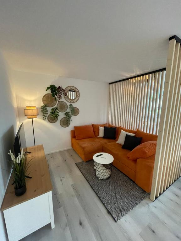 a living room with a couch and a table at xiApartment in Höchst