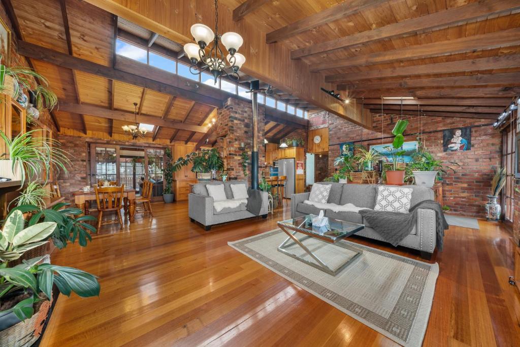 a living room filled with furniture and plants at Sea view holiday plant house , close to CBD and Beach in Kingston Beach