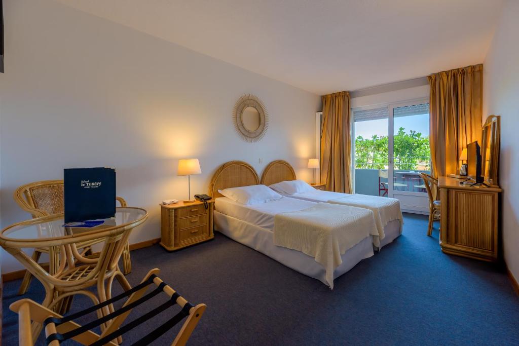 Postel nebo postele na pokoji v ubytování Hotel Le Tilbury