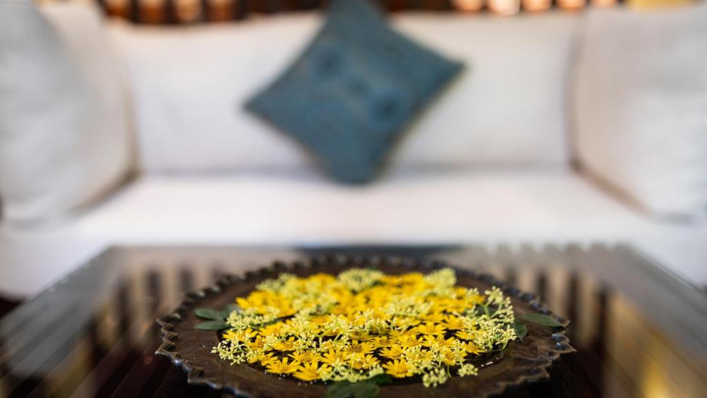 a plate of flowers on a table with a star at Lynnaya Urban River Resort in Siem Reap