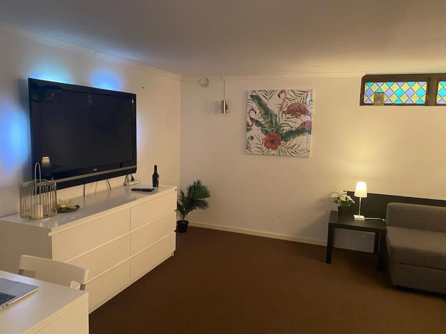 a living room with a large flat screen tv at Entire Basement Level in Eneby in Norrköping