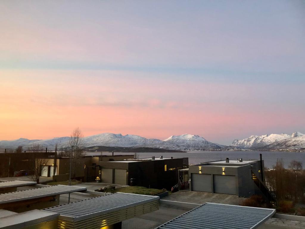 a view of the mountains from the roof of a building at Northstay - House of Northern Lights in Tromsø