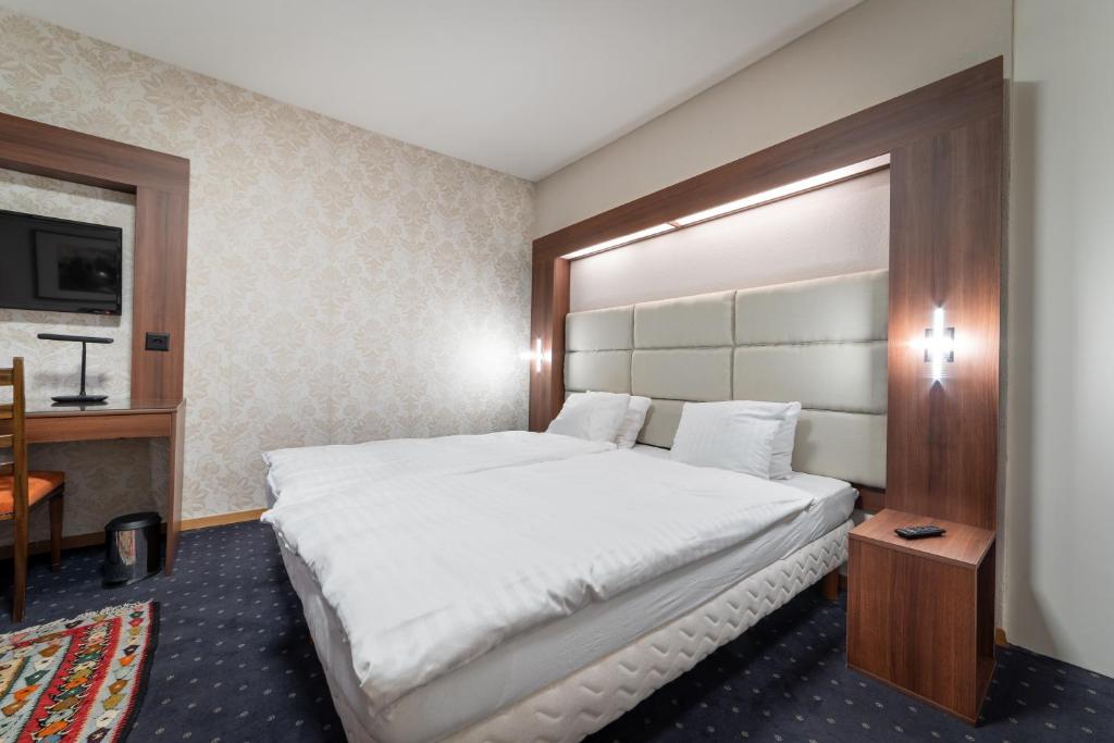 Postel nebo postele na pokoji v ubytování Hotel Restaurant Kutchi