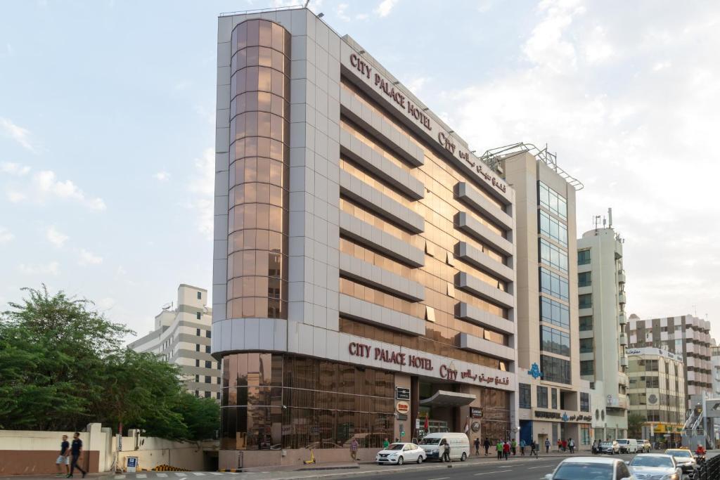 un palazzo alto con un cartello sulla parte anteriore di CITY PALACE HOTEL a Dubai