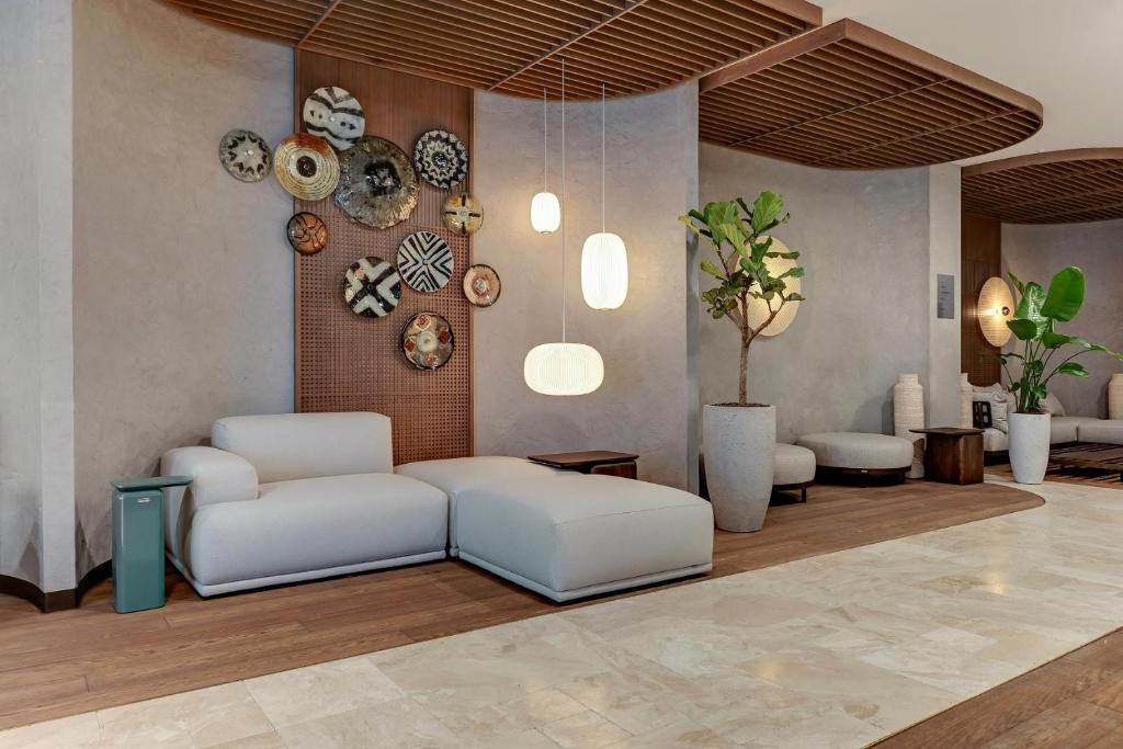 a living room with a couch and plates on the wall at GRANO HOTEL Solmarina in Wiślinka