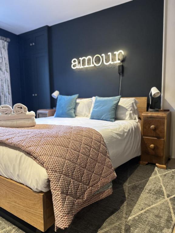 a bedroom with two beds and an amu sign on the wall at Unique Clifton apartment on historic crescent in Bristol