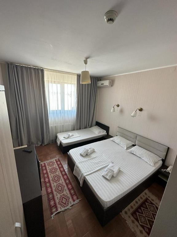 Postel nebo postele na pokoji v ubytování Hotel Promenada