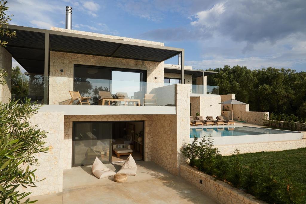 a modern house with a swimming pool at Luxury Stone Houses Corfu in Píthos