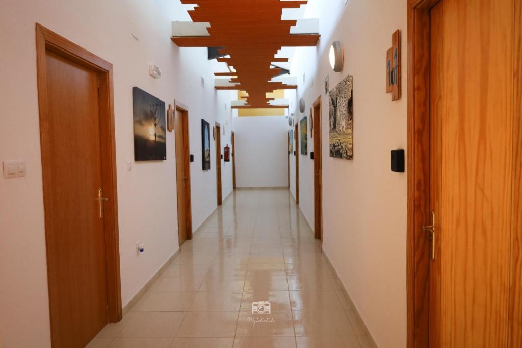 a corridor of a building with a long hallway at Hospedium Hostal Ben Nassar in Arjona