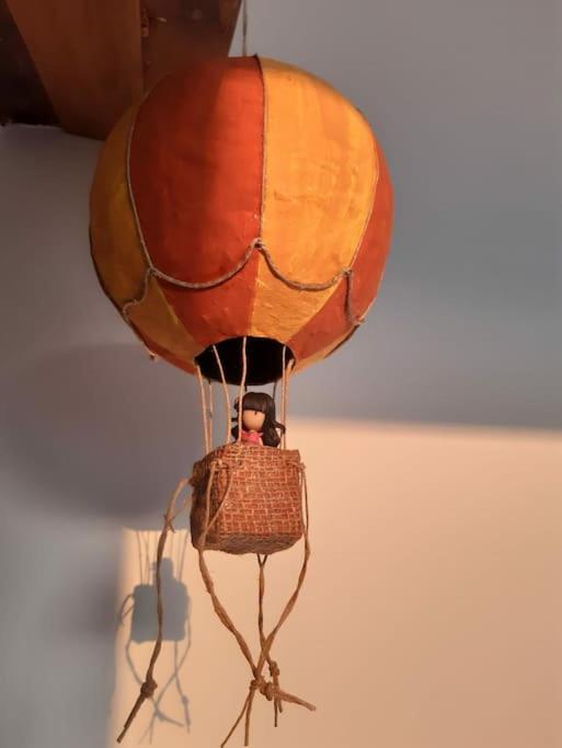 a hot air balloon with a person in a basket at La Mansarda delle Mongolfiere in Turin
