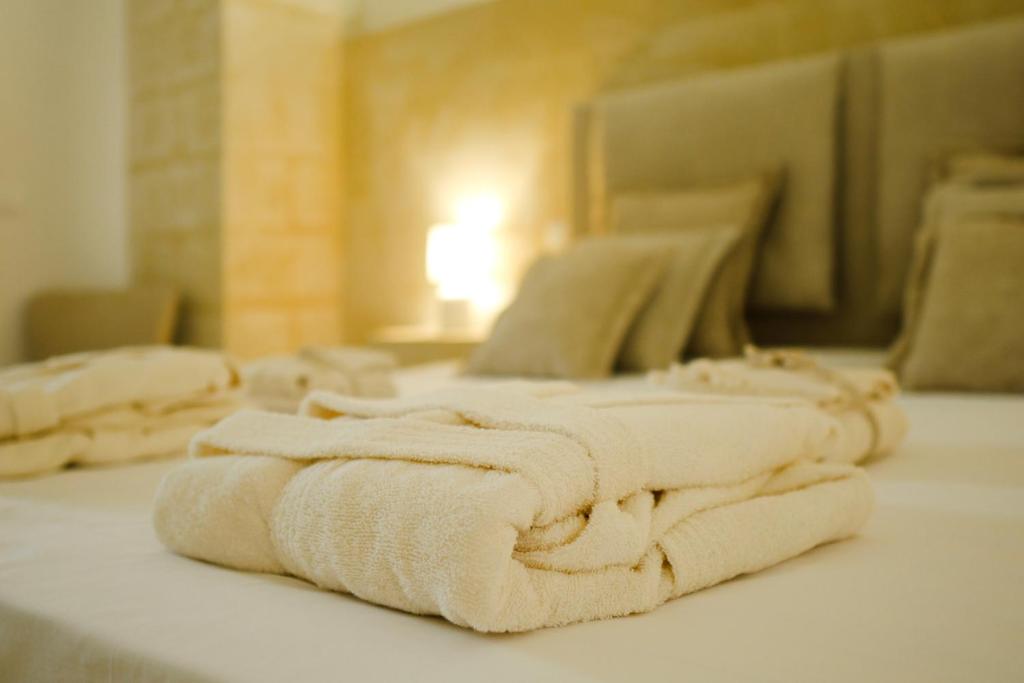 Postel nebo postele na pokoji v ubytování Masseria Paralupi
