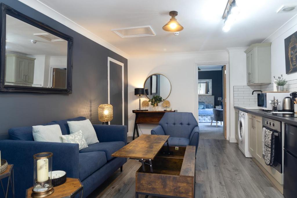 sala de estar con sofá azul y mesa en No5, One-Bedroom Apartment, Willowbrook House, en Bedworth