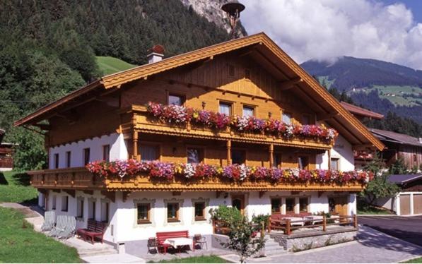 a building with flowers on the side of it at Walchenhof in Mayrhofen