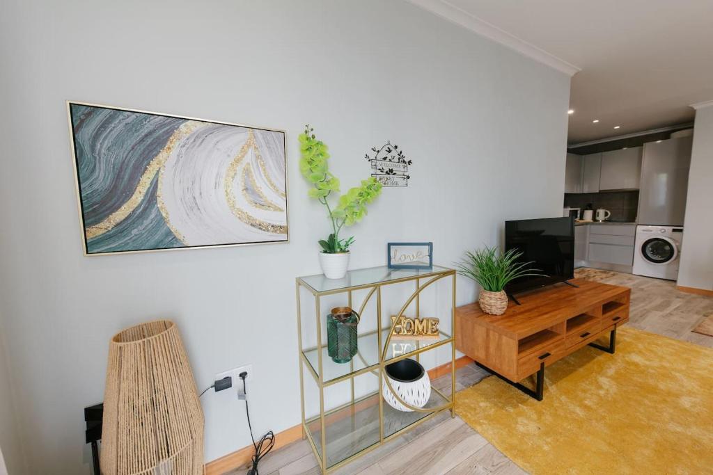 a living room with a table and a tv at SWEET home I in Caniçal