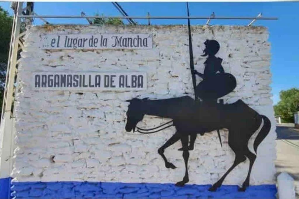 a painting of a woman riding a horse next to a wall at Apto. Singular en la Mancha Banco de Inversiones in Argamasilla de Alba