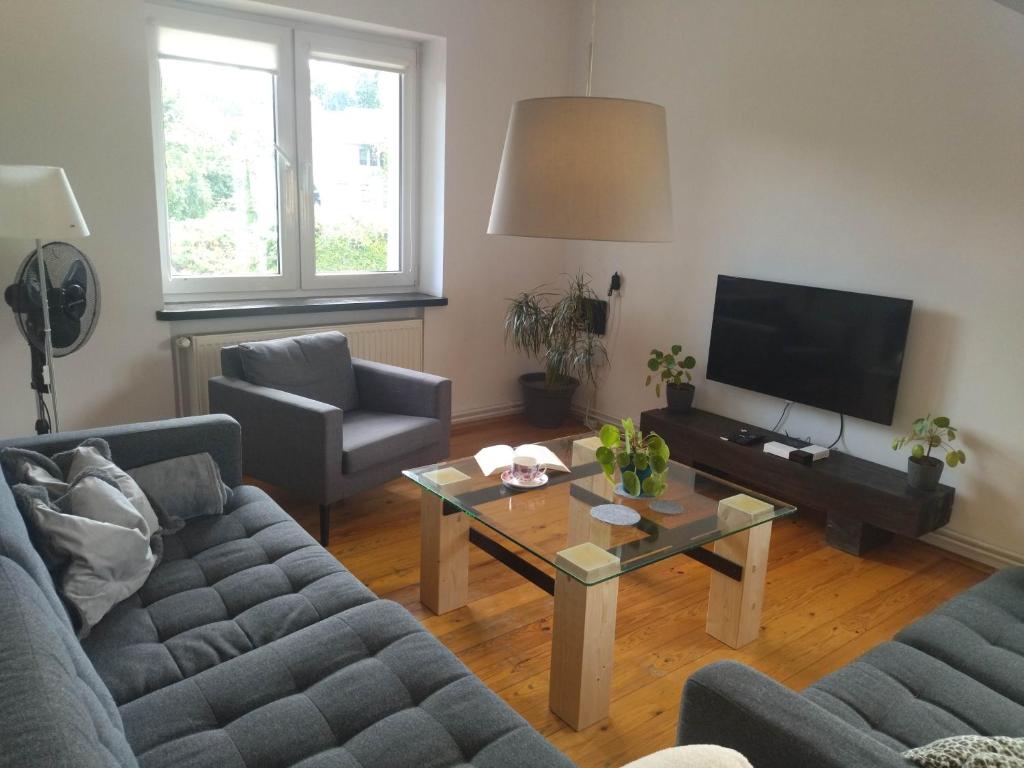 a living room with two couches and a coffee table at Apartamenty 47 in Dorotowo