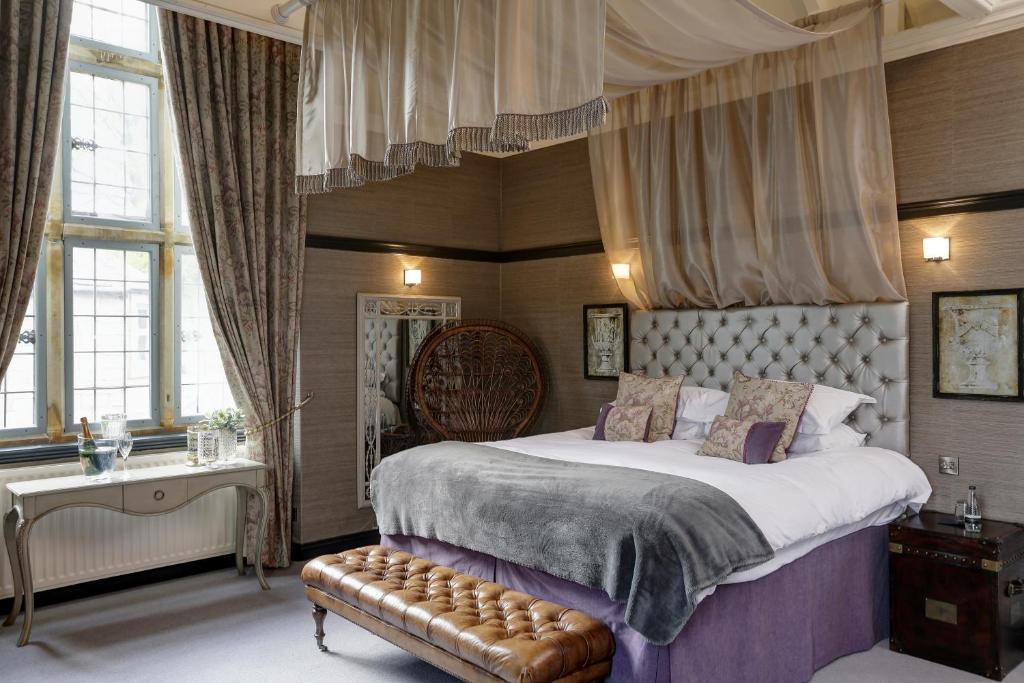 een slaapkamer met een groot bed met een baldakijn bij Falcon Manor Hotel in Settle