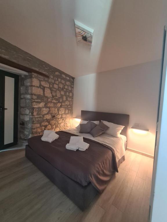 a bedroom with a large bed with towels on it at Il Campanile in Santa Maria del Molise