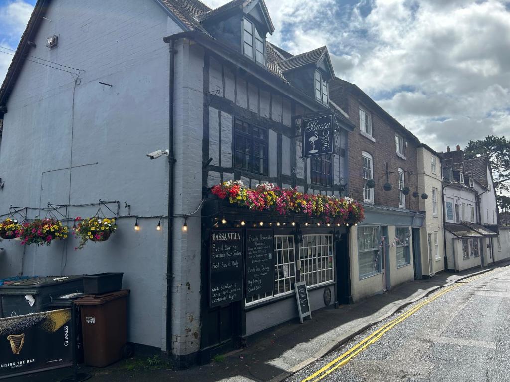 a building with flower boxes on the side of it at Bassa Villa in Bridgnorth