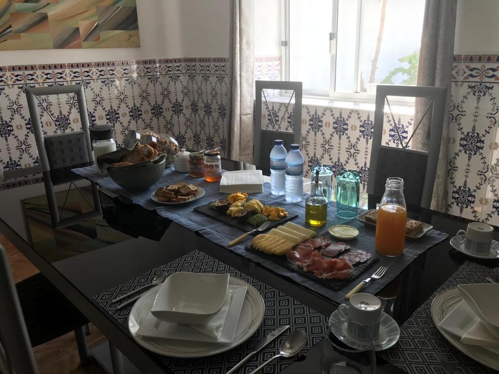 a breakfast table with food and drinks and a table with food at Casa Santo Antonio in Pias